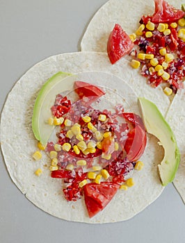 Mexican tacos with vegetarian fillings on light table, cooking process