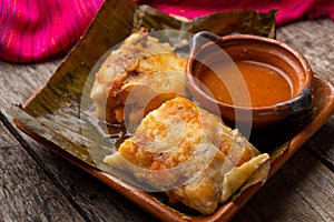 Mexican tamales wrapped in banana leaves also called OaxaqueÃÂ±os photo