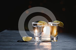 Mexican Tequila with lime and salt on wooden table, selective focus. Copyspace