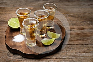 Mexican Tequila shots, lime and salt on table photo