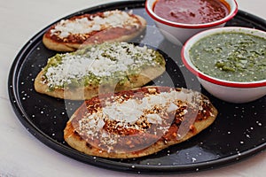 Mexican tlacoyos with green and red sauce, Traditional food in Mexico photo