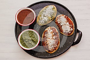 Mexican tlacoyos with green and red sauce, Traditional food in Mexico photo