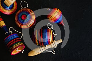 Mexican toys from Wooden, balero, yoyo and trompo in Mexico on black background photo