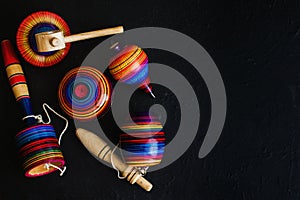 Mexican toys from Wooden, balero, yoyo and trompo in Mexico on black background photo