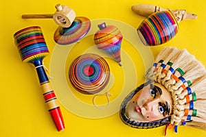 Mexican toys from Wooden, balero, yoyo and trompo in Mexico on a yellow background photo