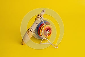 Mexican toys from Wooden, balero, yoyo and trompo in Mexico on a yellow background