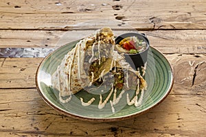 Mexican wheat tortilla burrito with pico de gallo, rice, cream cheese, jalapenos and chili con carne photo
