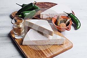 Mexican white Cotija cheese, tequila shot with fresh ingredients in Mexico Latin America