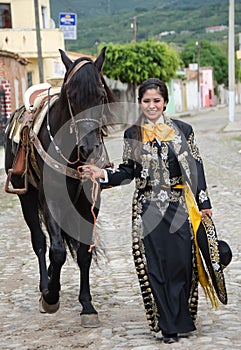 Mexican woman and black horse photo