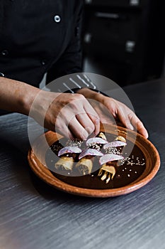 Mexican woman cooking mole poblano enchiladas traditional food in a restaurant in Mexico