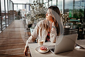 Mexican woman enjoys morning coffee on terrace of cafe. Mental health, wellness and slow living