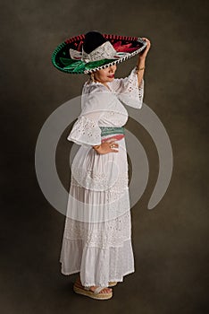 Mexican woman with positive attitude wearing a mariachi hat