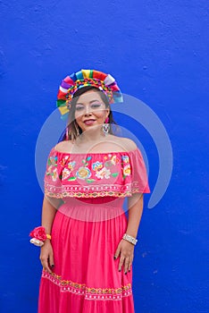 Mexican woman wearing embroidered dress and Lele doll headband.