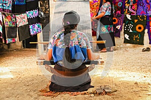 Mexican woman working loom in Chiapas Mexico photo