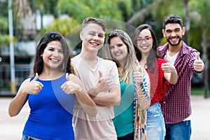 Mexican young adult woman with group of friends in line