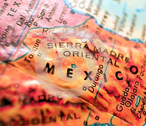 Mexico border map focus macro shot on globe for travel blogs, social media, web banners and backgrounds.