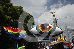 King`s crown, Rainbow flag and big eye among people marching in avenue de la Reforma next to winged victory in Mexico City  for LG