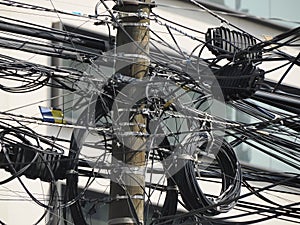 Mexico City Messed up power lines and connection cables. Many tangled wires on electric poles in the city