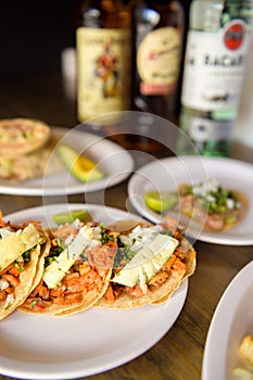 Mexico City, Mexico - September 14, 2020 - Mexican tacos, Mexican food concept. Famous bottles of alcoholic beverages on the bar t