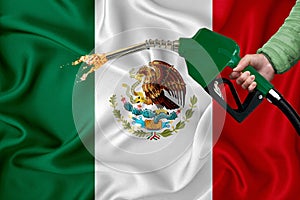 MEXICO flag Close-up shot on waving background texture with Fuel pump nozzle in hand. The concept of design solutions. 3d