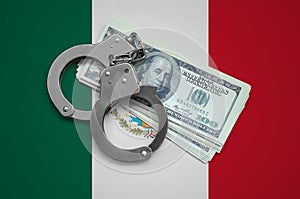 Mexico flag with handcuffs and a bundle of dollars. Currency corruption in the country. Financial crimes