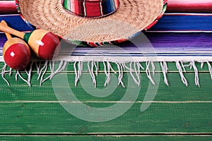 Mexico mexican sombrero maracas fiesta wood background border top edge photo