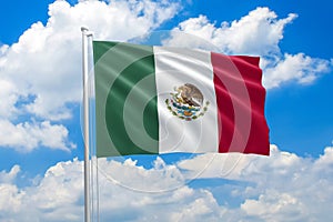 Mexico national flag waving in the wind on clouds sky. High quality fabric. International relations concept