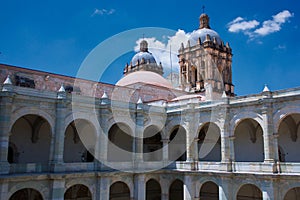 Mexico Oaxaca Santo Domingo monastery courtyard colonnade gallery and church tower with cross