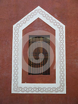 Mexico: painted frame of wooden window in plaster wall