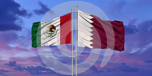 Mexico and Qatar flag waving in the wind against white cloudy blue sky together. Diplomacy concept, international relations