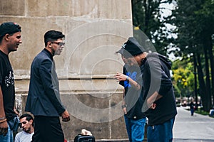 MEXICO - SEPTEMBER 20: Young men having a rap battle at the Beethoven Plaza in downtown while a crowd of people is watching