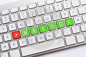 MEXICO writing on white keyboard with a aircraft sketch