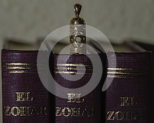 Mezuzah pendant next to The Book of The Zohar photo