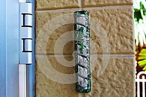 Mezuzah. Religious attribute at the entrance to a house. Large Decorative Mezuzah at the entrance to a modern residential building