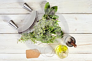 Mezzaluna knife, bouquet garni, olive oil and salt photo