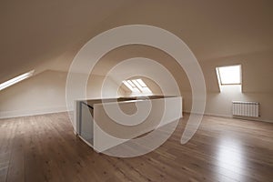 Mezzanine room with sloping ceilings with skylights and chestnut flooring