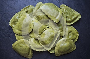 Mezzelune green fresh pasta with gorzonzola, speck and caramelised onion photo