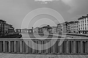 Mezzo Bridge over the Arno River seen Buildings on the banks of the Arno River in Pisa, Italy