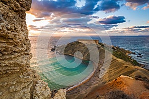 Mgarr, Malta - Panorama of Gnejna bay, the most beautiful beach in Malta at sunset