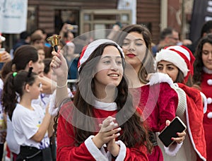 Support group members dressed as Santa Claus entertain participants and visitors of the annual race `Cristmas Run` in Mi`ilya in I