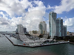 Miami Beach downtown coast boat pier and skyscrappers view from the deck of the cruise ship, Florida, US photo