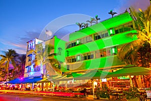 Miami Beach, Florida Moving traffic hotels and restaurants at sunset on Ocean Drive photo