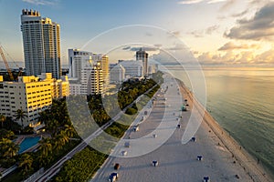Miami Beach, Florida, USA - Sunrise aerial view of luxury condominiums and hotels with the Miami skyline in the