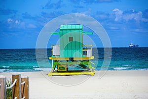 Miami Beach with lifeguard tower and coastline with colorful cloud and blue sky. Sunny summer day, with blue sky and