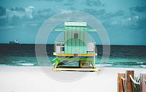 Miami Beach with lifeguard tower and coastline with colorful cloud and blue sky. Sunny summer day, with blue sky and