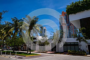 Miami Beach Street. Florida, USA. South Beach. Buildings and palm trees. Small buildings and skyscrapers nearby. Summer