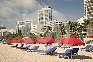 miami beach with sunloungers and umbrellas for summer vacation