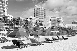 miami beach with sunloungers and umbrellas for summer vacation