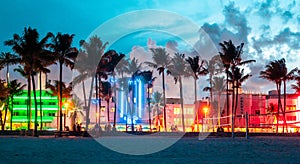 Miami Beach, USA - September 10, 2019: Ocean Drive hotels and restaurants at sunset. City skyline with palm trees at