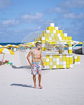 Miami beach, young men on the beach at Miami beach, lifeguard hut Miami beach Florida